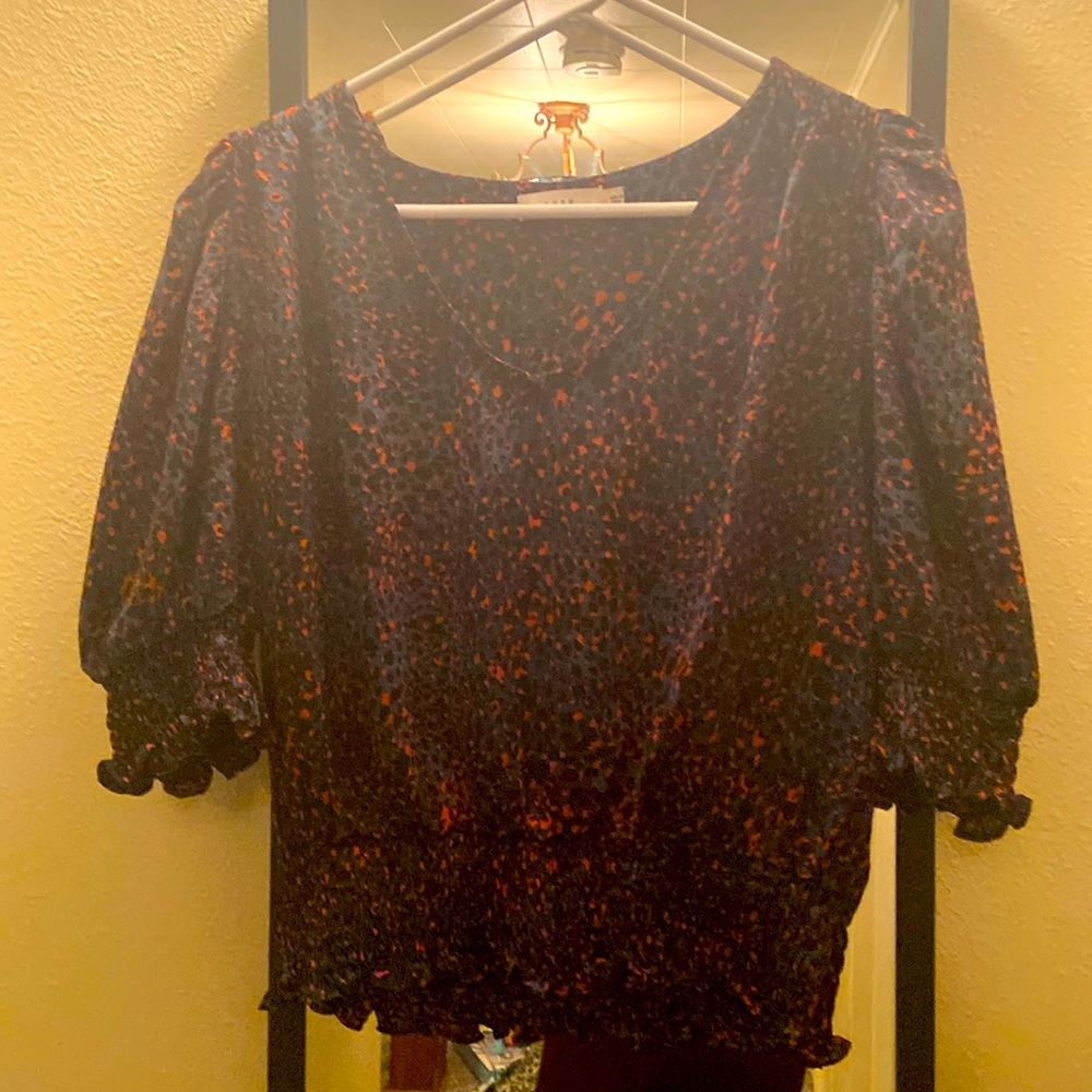 Super fun, sexy blouse with lightly puffed shoulders.